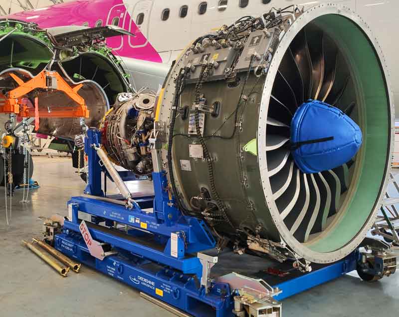 Dedienne Aerospace Pw1100 engine stand in a maintenance hangar