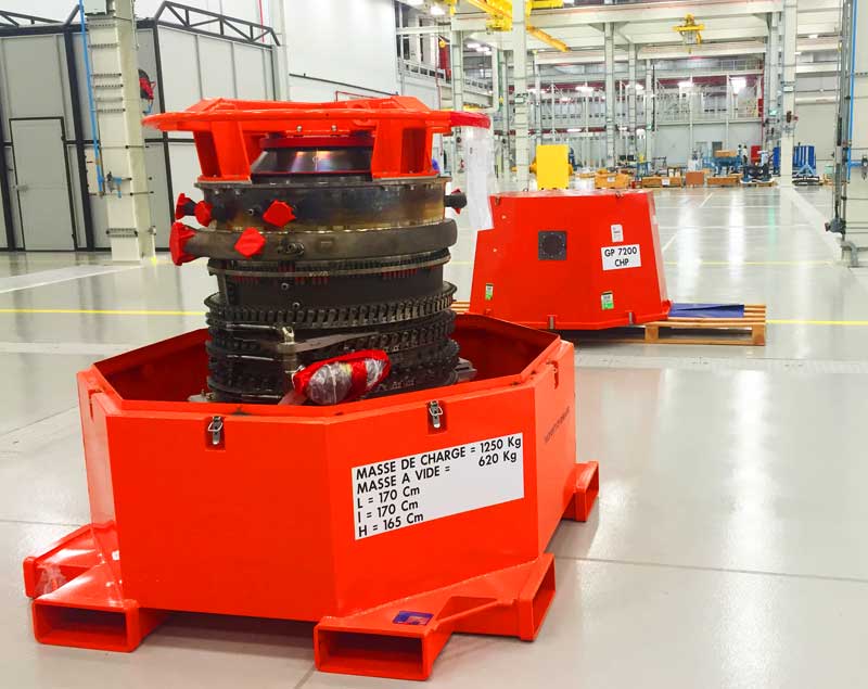 Dedienne Aerospace red shipping containers in a workshop