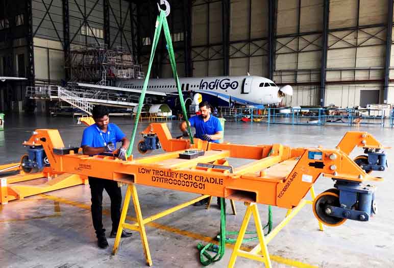 Dedienne Aerospace quality operators are repairing an engine stand in a maintenance hangar